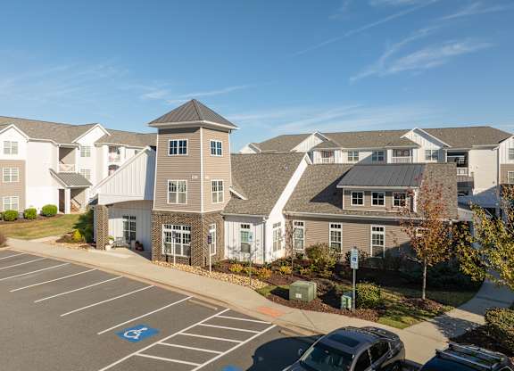 A parking lot with a car and a handicap sign. at Concord Ridge Apartments, Concord, North Carolina