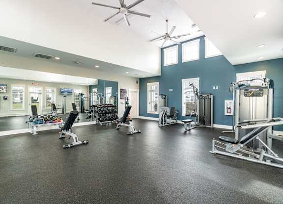 A gym with a variety of equipment including weights and cardio machines. at Concord Ridge Apartments, Concord