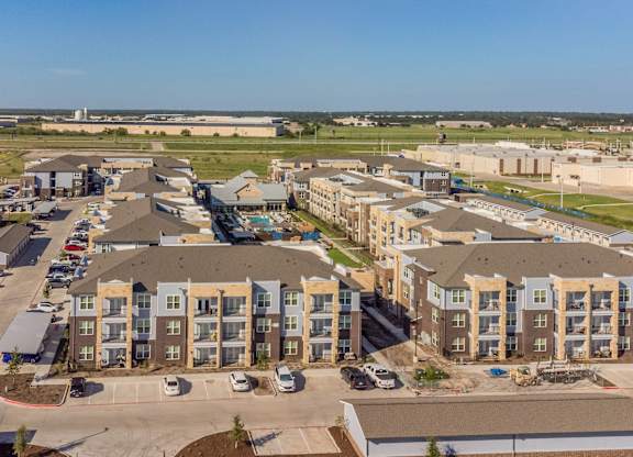 an aerial view of an apartment complex with cars parked in a parking lot at Magnolia Grove Apartments, Terrell, TX