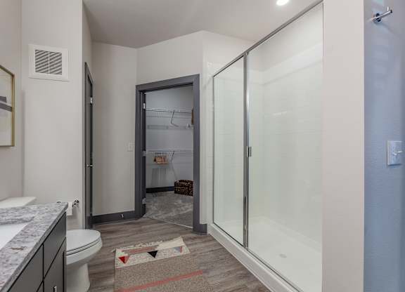A bathroom with a toilet, sink, and shower. at Magnolia Grove Apartments, Terrell, Texas
