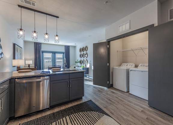 A modern kitchen with dark wood cabinets and stainless steel appliances. at Magnolia Grove Apartments, Terrell, TX, 75160