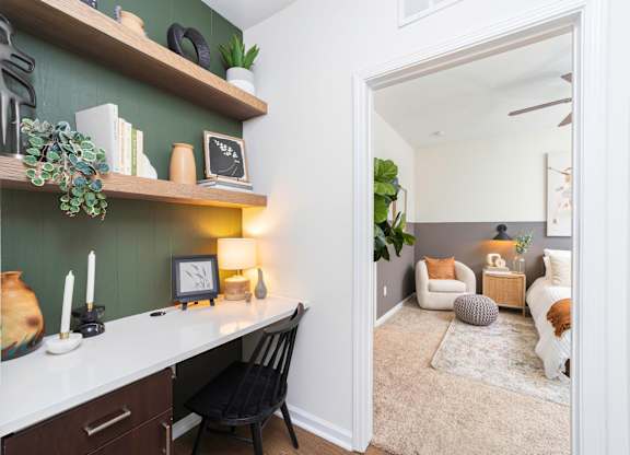 a living room with a desk and a mirror at Terraces at Town Center, Florida