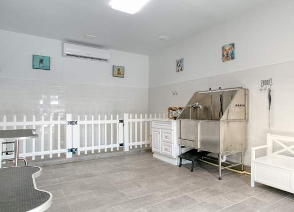 a room with a pet washing station and a white fence at Terraces at Town Center, Florida, 32256
