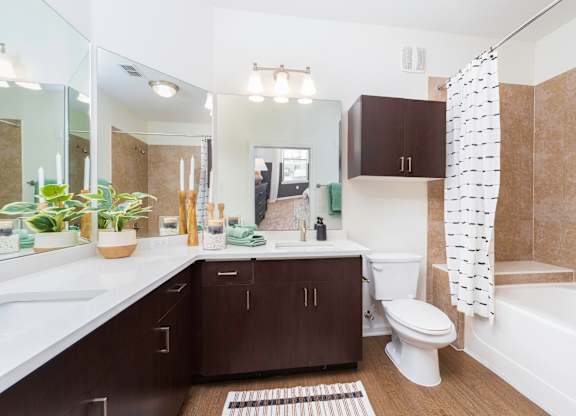 a bathroom with a white toilet and a bath tub at Terraces at Town Center, Jacksonville, 32256