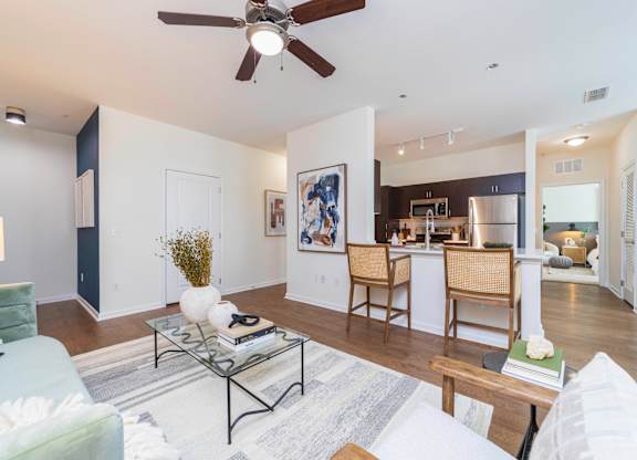 an open living room and kitchen with a ceiling fan at Terraces at Town Center, Jacksonville