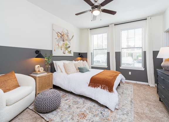 a bedroom with a large bed and a ceiling fan at Terraces at Town Center, Jacksonville, Florida