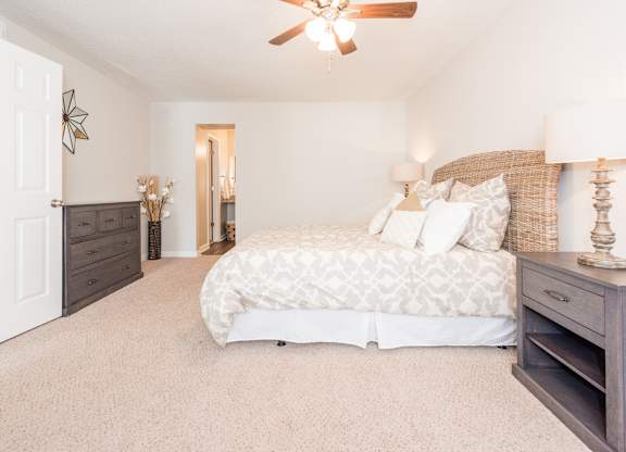 A bedroom with a large bed and a ceiling fan. at WildForest Apartments, Birmingham, Alabama