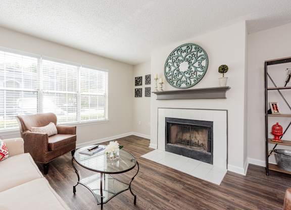 A living room with a fireplace and a couch. at WildForest Apartments, Birmingham, 35209