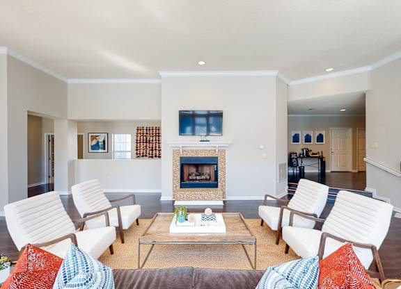 a living room with white furniture and a fireplace at WildForest Apartments, Alabama