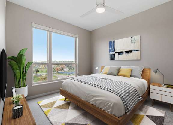 bedroom with queen bed and ample natural light at The Hallon Apartments, Hopkins, Minnesota