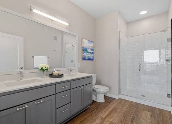spacious modern bathroom with ample storage and spa shower at The Hallon Apartments, Minnesota