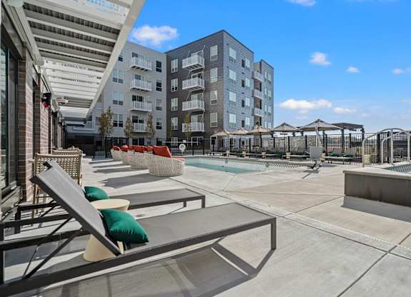 pool with lounge chairs at The Hallon Apartments, Hopkins, Minnesota