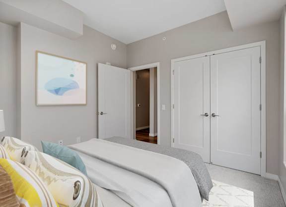 bedroom with French door closets at The Hallon Apartments, Hopkins,