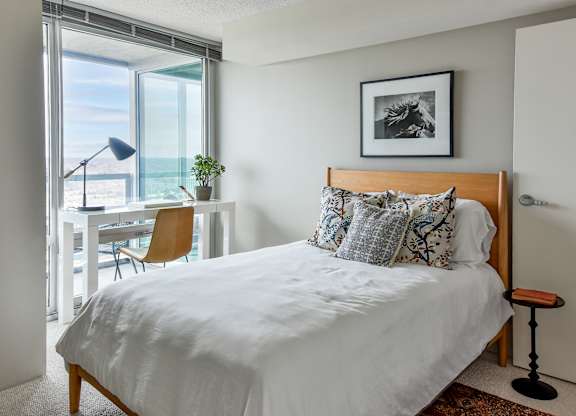 a bedroom with a bed and a view of the ocean at Optima Old Orchard Woods, Illinois