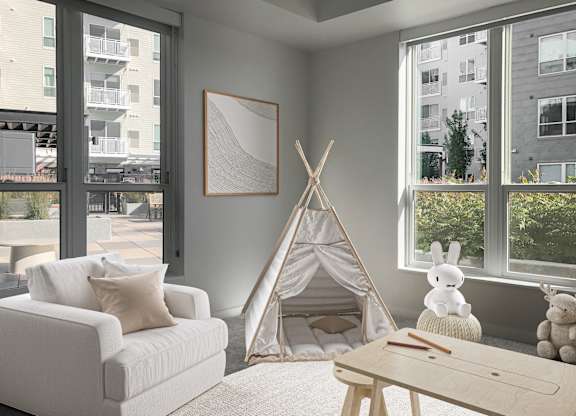 a living room with a teepee and a couch and a coffee table