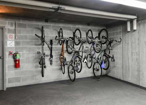 a parking garage with bikes hanging on the wall at Optima Old Orchard Woods, Illinois, 60077