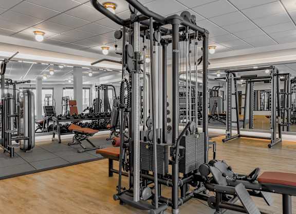 A gym with a variety of equipment including a leg press machine.