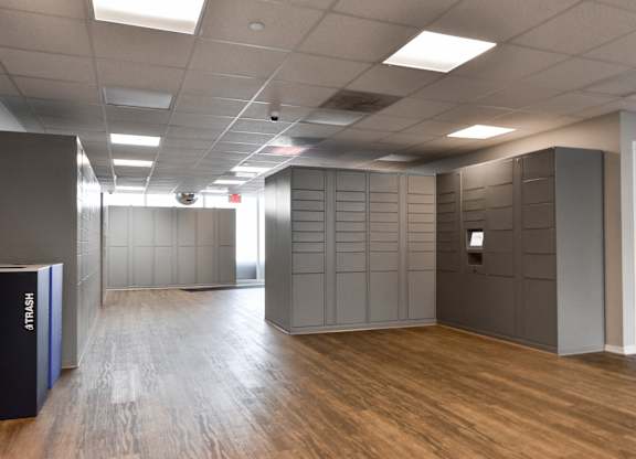 a large room with wooden floors and grey lockers at Optima Old Orchard Woods, Skokie, Illinois