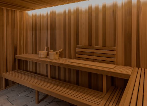 A wooden sauna with benches and towels.
