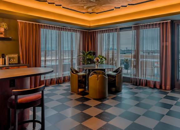 A room with a checkered floor and a bar area.