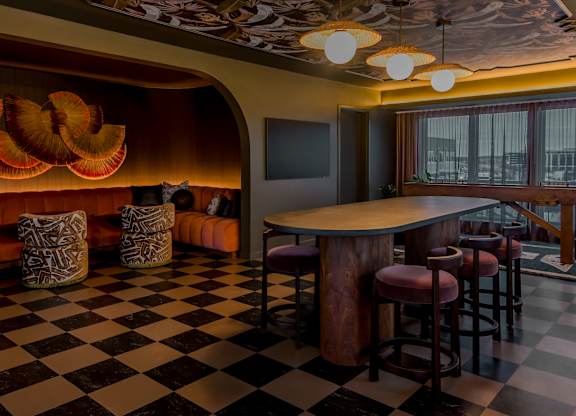 A black and white checkered floor in a room with a bar.