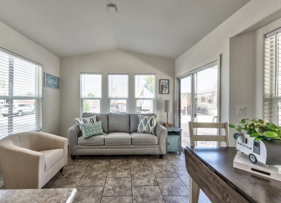 a living room with a couch and a table and a chair