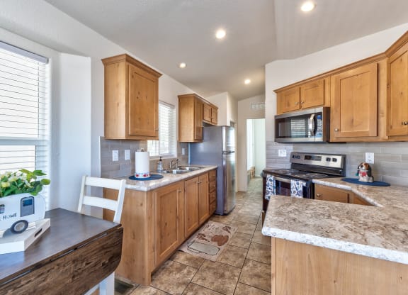 a kitchen with wooden cabinets and stainless steel appliances
