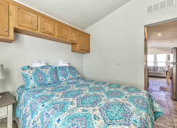 a bedroom with a bed and a door to a bathroom