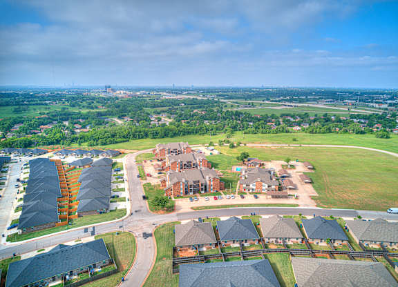 A suburban neighborhood with houses and a large open field.