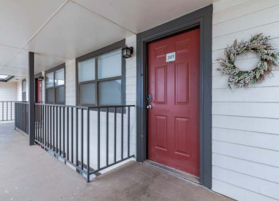 A red door with a number 301 on it.