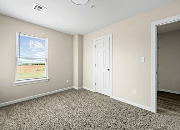 A room with a window and a door.