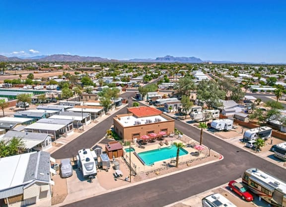 an aerial view of a city with a pool and buildings