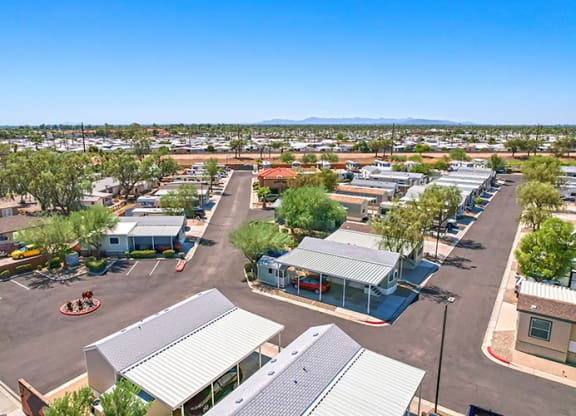 an aerial view of a parking lot with parked cars and buildings