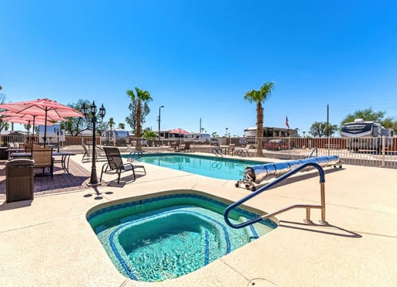 our resort style swimming pool is open to the community and has tables and chairs around