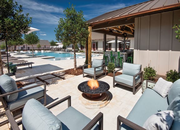 fire pit with seating on the pool deck