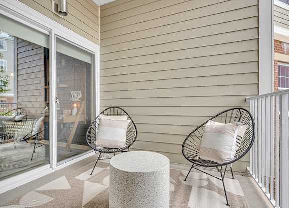 A patio with two chairs and a table.