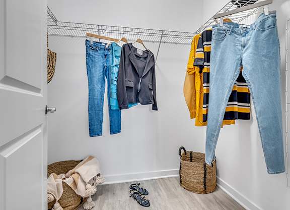 A pair of jeans is hanging on a clothes rack.