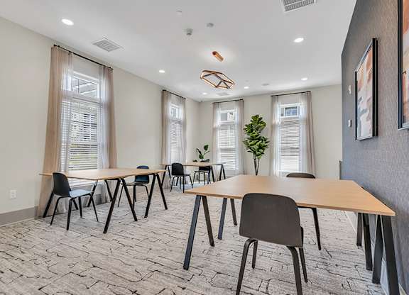 A conference room with a long table and chairs.