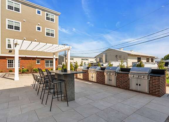 A patio with a table and chairs is in front of a building.