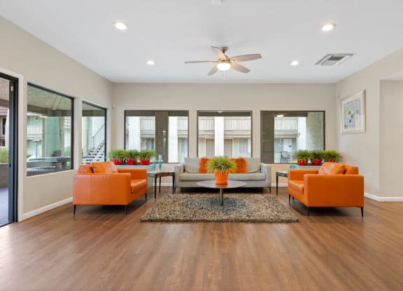 Living room with couches and a table at Verde Apartments in 85719