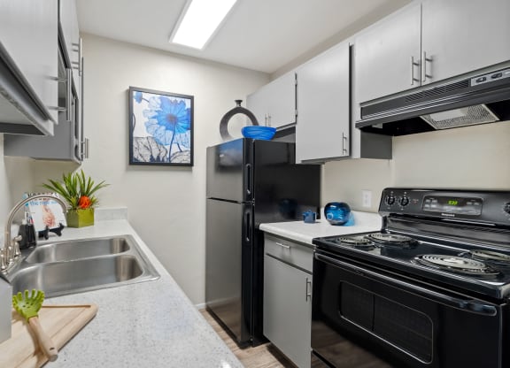 Kitchen with stainless steel appliances and a stove and refrigerator at Verde Apartments in Tucson, 85719