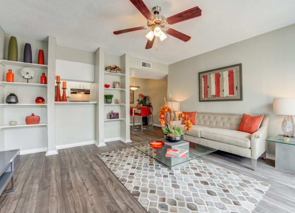 a living room with a ceiling fan and a couch at Sundance and Sausalito Apartments, College Station, Texas