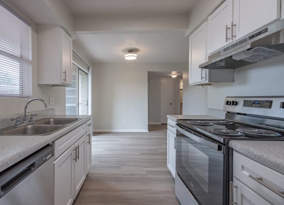 Kitchen with white cabinets and a stainless steel stove  at Riverstone, Bryan