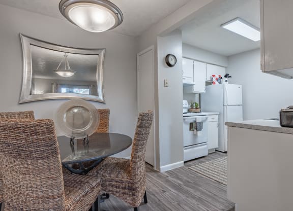 Dining area with a table and chairs and a kitchen in the background  at Riverstone, Bryan, TX