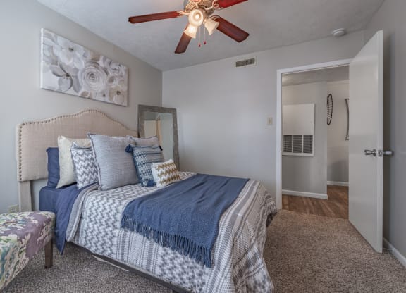 Bedroom with a bed and a ceiling fan  at Riverstone, Bryan, TX, 77802