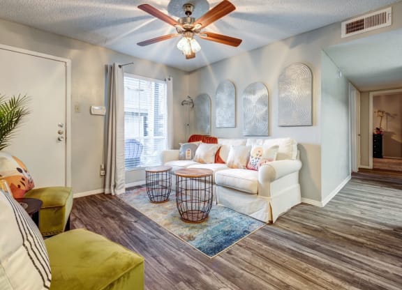 Living room with a white couch and a ceiling fan  at The Wick, Texas, 77840