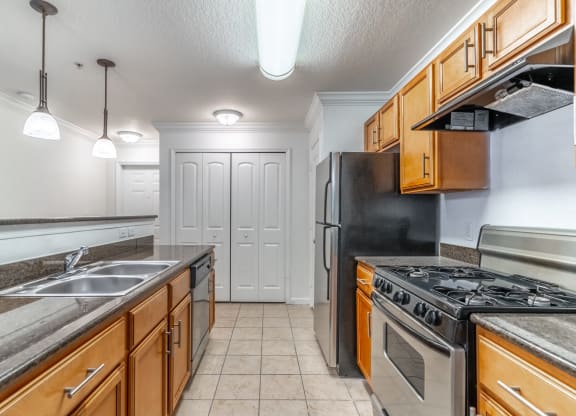 a kitchen with stainless steel appliances and wooden cabinets