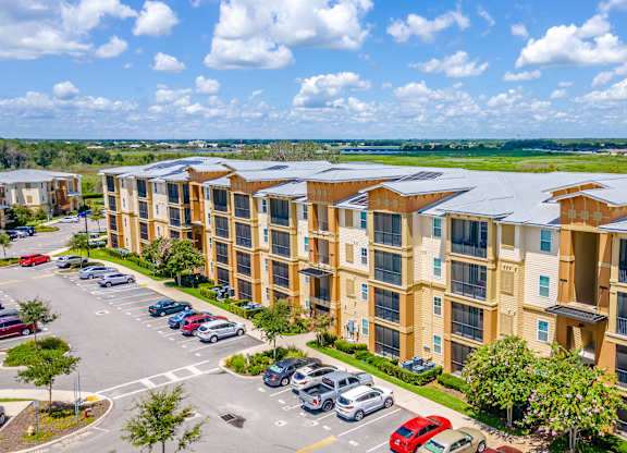 A large apartment complex with solar panels on the roofs.