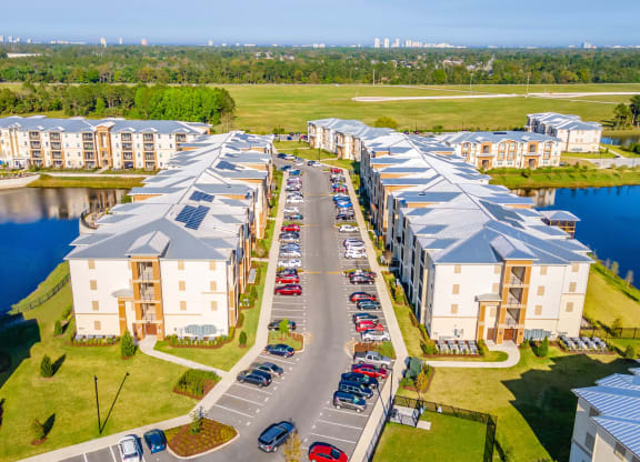 an aerial view of an apartment complex next to a lake