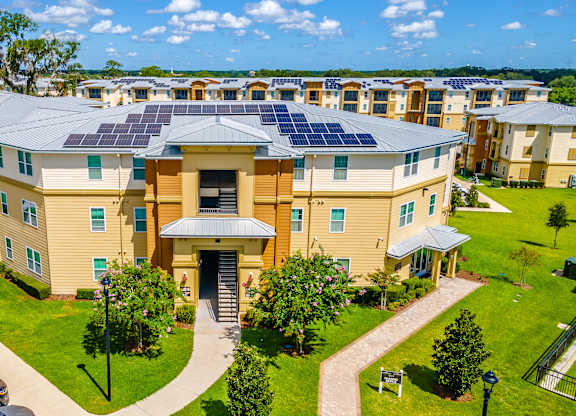 A large building with a lot of windows and solar panels on the roof.